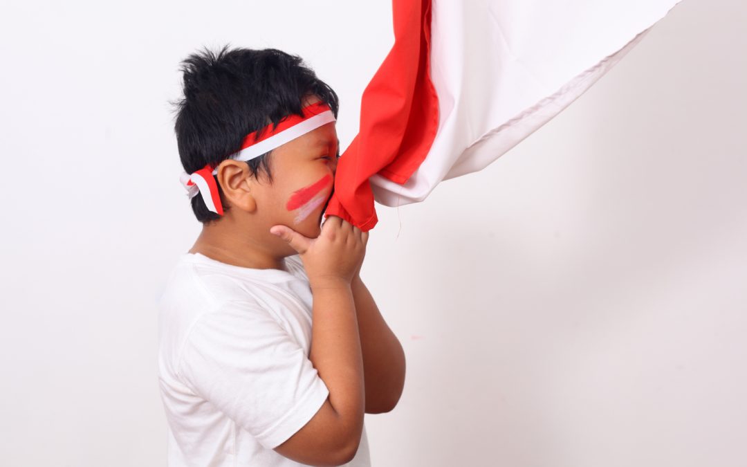ilustrasi anak laki-laki mencium bendera merah putih